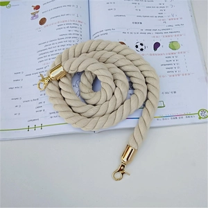 Beige braided cotton rope bag strap with gold lobster clasps in spiral layout