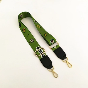 Adjustable green shoulder strap featuring cute avocado patterns and gold metal hooks