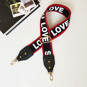 Ethnic style wide bag strap with red edges and white LOVE lettering on black fabric