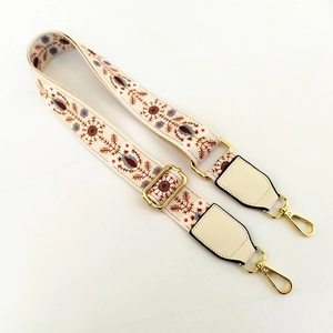 Detail of bohemian floral wide shoulder strap with gold metal lobster clasps