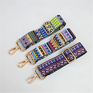 Detailed view of three adjustable ethnic style woven purse straps with gold metal hardware