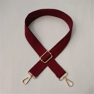 Detail of adjustable wine red canvas shoulder strap with gold metal lobster clasps