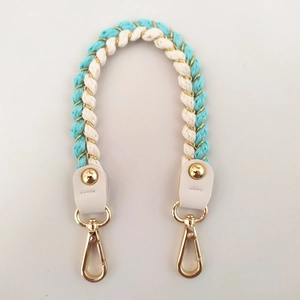 Detail of woven turquoise and white strap with gold metallic thread and lobster clasp