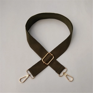 Detail of adjustable cotton canvas shoulder strap with gold metal lobster clasps