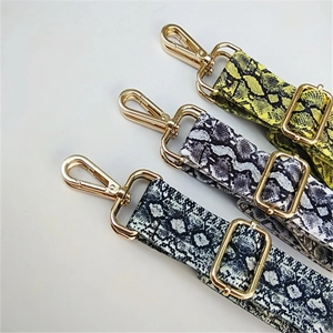 Adjustable faux snakeskin shoulder strap set with metallic gold hardware for handbags