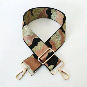 Detail of camouflage bag strap with sequins, light gold lobster clasps and metal buckle