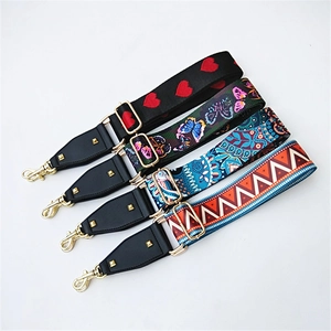 Detail of adjustable colorful wide bag straps with gold rivets and lobster clasps