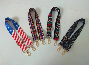 Close-up of four adjustable ethnic style replacement bag straps with gold metal clips