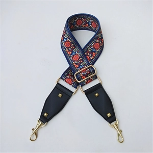 Detail of bohemian floral jacquard strap with gold lobster clasps and black leather ends