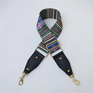 Close-up of bohemian colorful woven bag strap with golden buckles and metal rivets