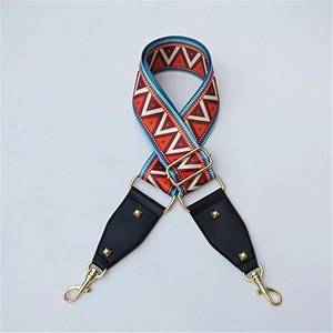 Detail of colorful geometric woven bag strap with ethnic patterns and gold hardware