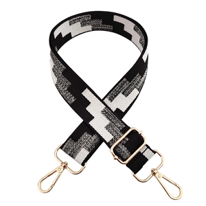 Adjustable wide replacement bag strap with black and white zigzag pattern and gold hardware