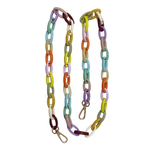 Close-up of colorful acrylic link chain with gold metal lobster clasps for bags