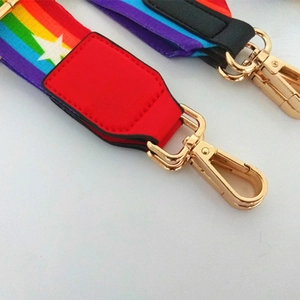 Adjustable rainbow striped bag strap with white star patterns and gold metal hooks