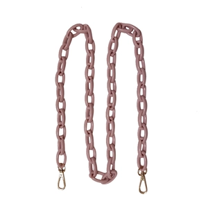 Close-up of dusty pink acrylic chain strap with gold metal lobster clasps for bags