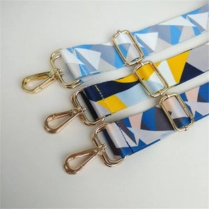Close-up of colorful ethnic geometric handbag straps with polished gold metal hardware