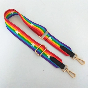 Adjustable rainbow striped bag strap with star patterns and gold hardware