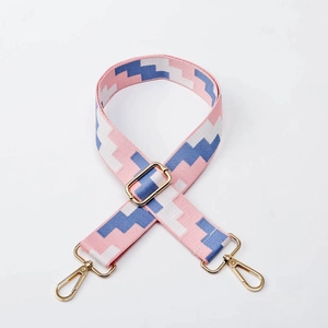Adjustable woven shoulder strap with pink blue pixel pattern and gold metal hooks