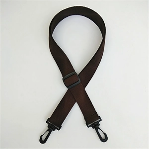 Macro detail of dark brown nylon strap with durable black plastic swivel hooks and buckle