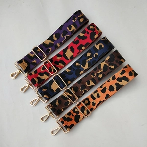 Close-up of five colorful leopard print bag straps with golden adjustable metal hooks
