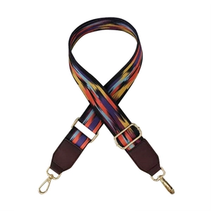 Detail showing bohemian rainbow pattern on wide shoulder strap with gold metal hooks
