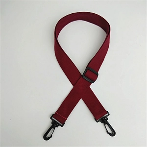 Detail of adjustable wine red nylon shoulder strap with black swivel hooks for bags