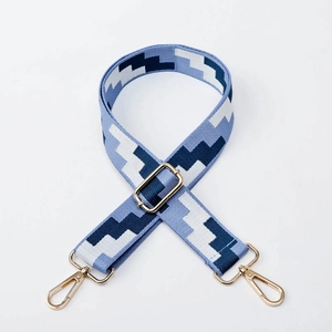 Adjustable woven shoulder strap with blue geometric pattern and gold metal hardware