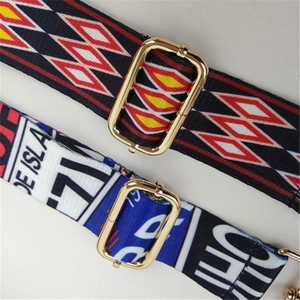 Close-up of adjustable bag straps with ethnic patterns and gold metal buckles