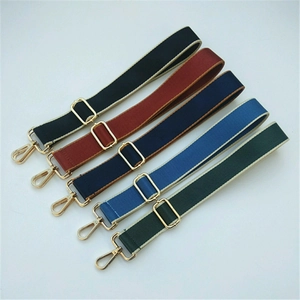 Close-up of five adjustable nylon bag straps in diverse colors with gold metal hooks