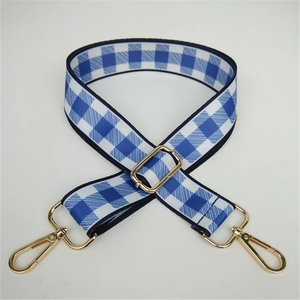 Close-up of adjustable blue and white checkered nylon strap with gold lobster clasps