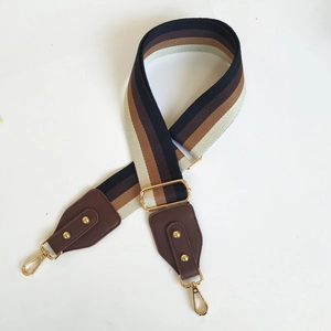Adjustable striped wide canvas shoulder strap with brown leather and gold metal hooks