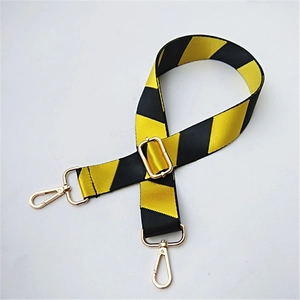 Adjustable wide replacement strap with yellow and black stripes and gold metal hardware