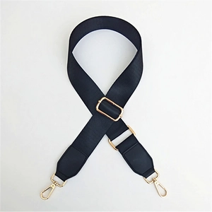 Detailed view of black nylon woven bag strap with golden metal hardware and swivel hooks
