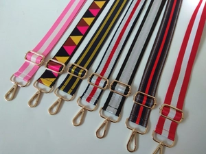 Detailed view of adjustable colorful guitar-style shoulder straps with gold metal hooks