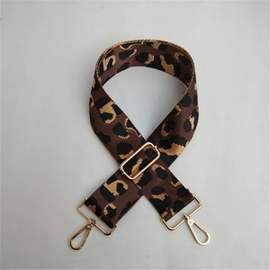 Detail of adjustable leopard print bag strap with gold lobster clasps and hardware