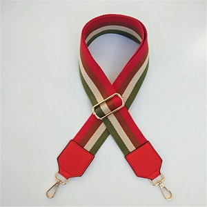 Close-up of bohemian colorful striped woven bag strap with red leather ends and gold hooks