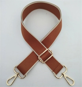 Detail of adjustable brown woven shoulder strap with gold-tone swivel lobster clasps