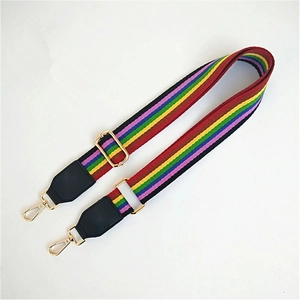Detail view of rainbow striped bag strap with gold metal hooks and black leather ends