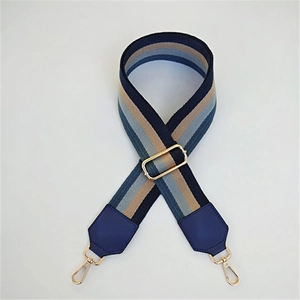 Detailed macro view of colorful striped woven bag strap with golden lobster clasps