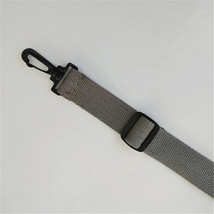Close-up of grey canvas strap texture with black plastic swivel hooks and adjuster