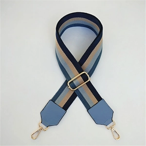 Adjustable wide woven shoulder strap with blue and brown stripes and gold hardware