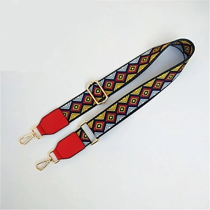 Close-up of geometric pattern strap with red leather ends and gold metal lobster clasps