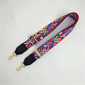 Detail of adjustable colorful geometric woven strap with gold metal lobster clasps