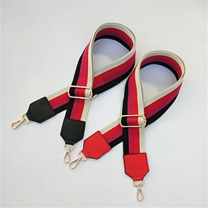 Detail of adjustable wide striped canvas straps with gold metal hooks and leather ends