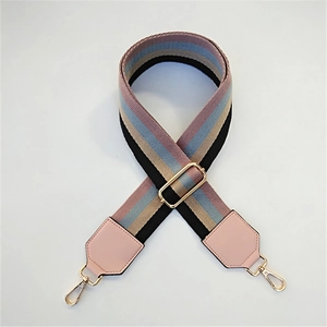 Close-up of adjustable striped PU leather shoulder strap with gold metal lobster buckles