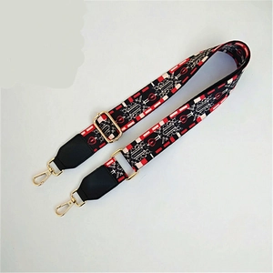 Macro view of geometric woven bag strap with golden metal hooks and leather joints