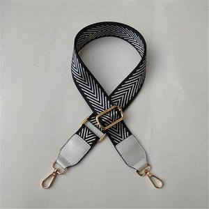 Adjustable chevron woven bag strap with golden metal hardware and gray leather ends