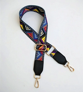 Detail of adjustable ethnic geometric woven strap with gold metal hooks and leather ends