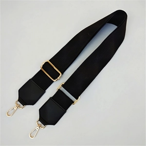 Detail of adjustable black nylon strap with gold buckles and leather reinforcements