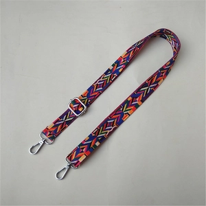 Detail of colorful ethnic woven shoulder strap with silver metal swivel hooks and buckle